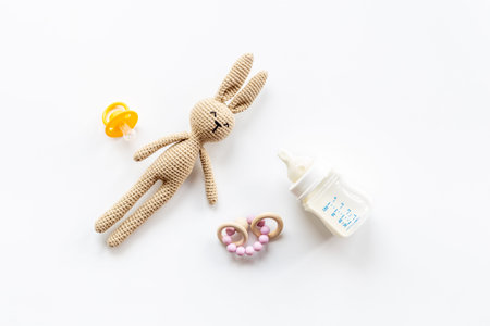 Child toy knitted rabbit with milk bottle, overhead view