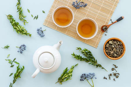 Tea ceremony with with white teapot and two cups, top viewの写真素材