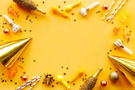 Confetti with party hats and balloons flat lay. Celebration backgroundの写真素材