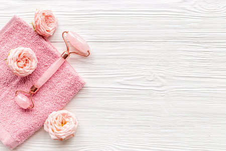 Face massage stone roller with rose flowers for skin beauty careの写真素材