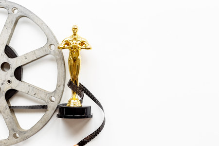 Golden film award statue with reel video tapeの写真素材