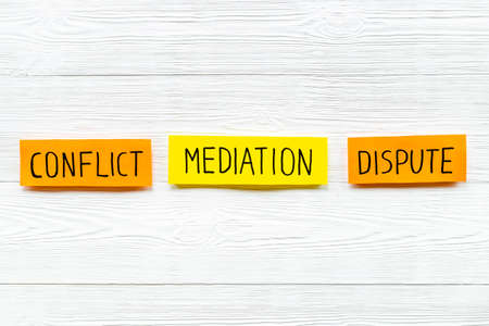 Word mediation on office table between conflict and dispute. Top viewの写真素材