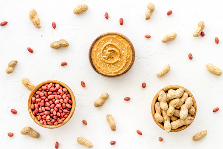 Bowls of homemade peanut butter and nuts on table, top viewの写真素材