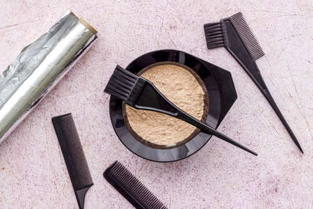 Hair dye mixing bowl with foil and brush. Flat layの写真素材