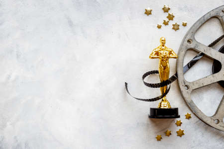 Golden film award statue with reel video tapeの写真素材