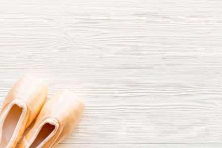 Pair of beige ballet pointe shoes with ribbon, top viewの写真素材