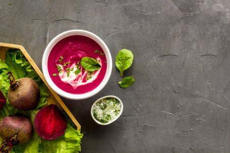 Cream soup made of red beet with raw beet rootsの写真素材