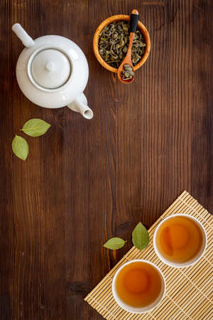 Tea ceremony with with white teapot and two cups, top viewの写真素材