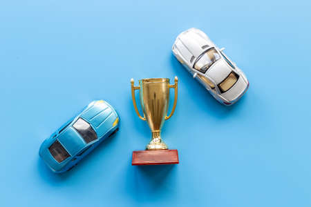 Sport rally car champion award - golden trophy cup with car models, top viewの写真素材