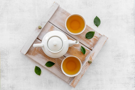 Tea ceremony with with white teapot and two cups, top viewの写真素材