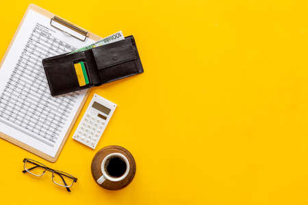 Calculating bills or taxes reports with with purse and bank cards, top viewの写真素材