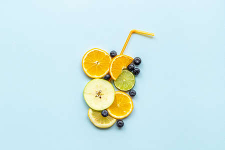 Cocktail concept. Glass of juice made of citrus and fruits with cocktail tubeの写真素材