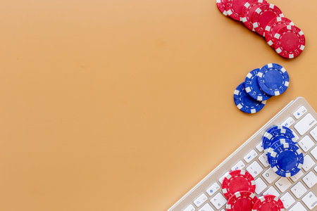 Gambling chips on keyboard. Online poker casino concept. Top view