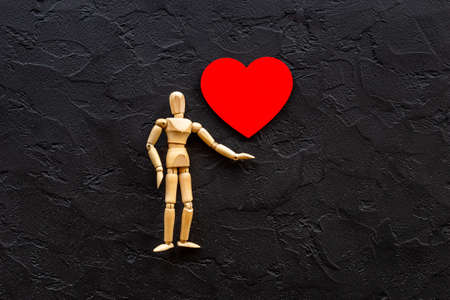 Love emotion concept. Wooden mannequin figure with heartの写真素材