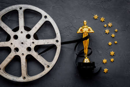 Golden film award statue with reel video tapeの写真素材