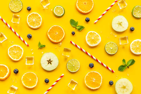 Slices citrus fruits and berries with with ice for making cocktail or juiceの写真素材