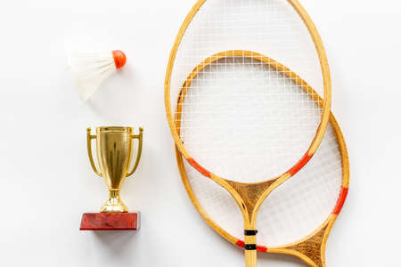 Small golden trophy cup with rackets and shuttlecock for winner, top viewの写真素材