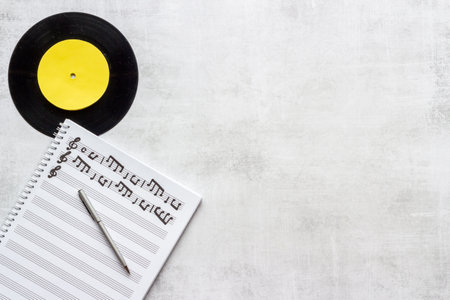 Handwritten music sheets and vinyl record, top view. Compose music conceptの写真素材