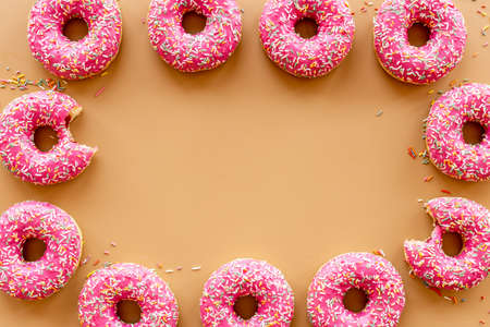 Pink donuts with sprinkles set, top view. Sweet bakery backgroundの写真素材