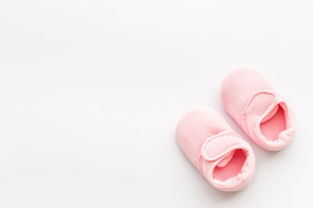 Baby girl pink newborn booties - child birth backgroundの写真素材