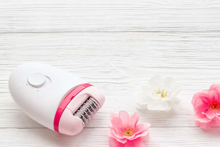 Epilator with pink and white flowers. Hair removal and depilatory conceptの写真素材