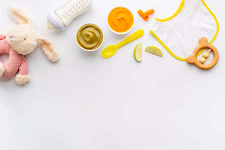 Baby fruits vegetables food with milk bottle and toyの写真素材