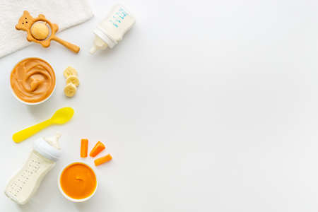 Baby food and milk bottle with kids accessories and toysの写真素材