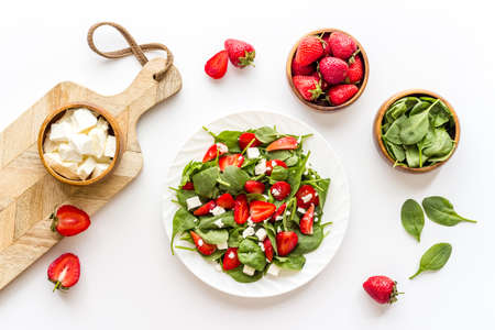 Fresh vegetarian green salad with strawberries and cheese, top viewの写真素材