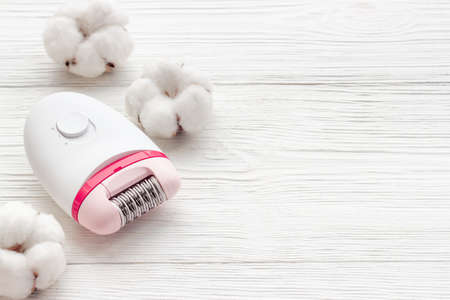 Epilator with cotton flowers. Hair removal and depilatory conceptの写真素材