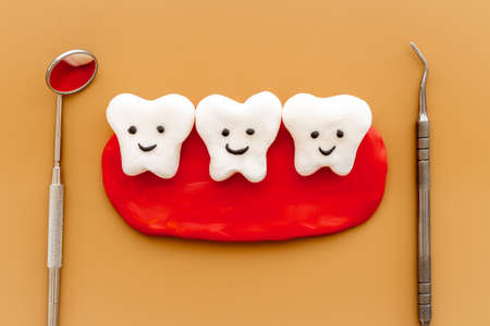 Teeth models with caries or plaque and dentist tools