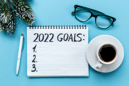 Goals 2022 - New Year goals planning, text in notebook. Top view, flat lay