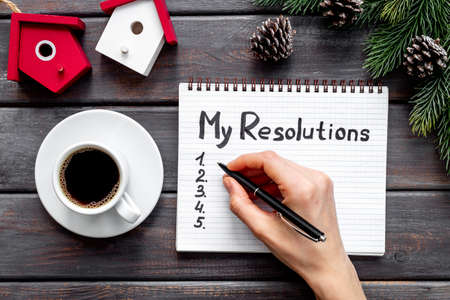 Resolutions of the year - New Year planning, text in notebook. Top view, flat lay.の写真素材