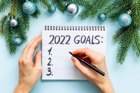 Goals 2022 - New Year plan, text in notebook. Top view, flat lay