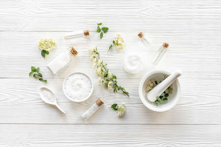 White herbal skin cream and bath salt - spa cosmetic with flowersの写真素材