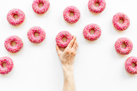 Pink glazed donutes background - set of donuts with icingの写真素材