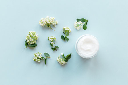 White moisturizing cream cosmetic for spa treatment with blossoms flowersの写真素材
