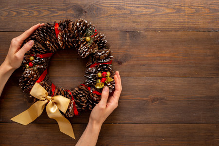 Festive Christmas wreath in hands. New year decoration backgroundの写真素材