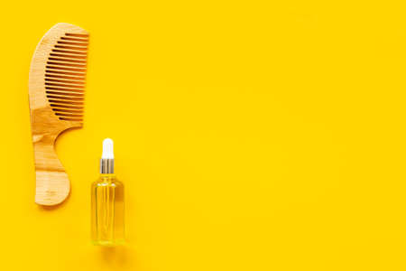 Essential oil for hair care with wooden hair combの写真素材