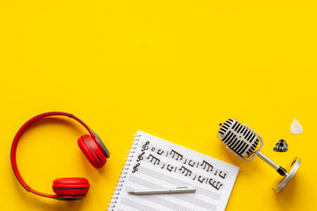 Music sheets with musical notes and headphones, top viewの写真素材
