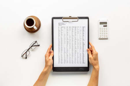 Businessman accounting taxes report or bills. Documents in hands top viewの写真素材