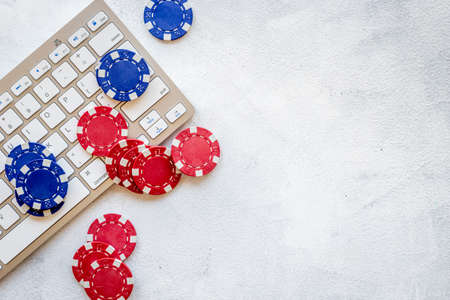 Gambling chips on keyboard. Online poker casino concept. Top viewの写真素材