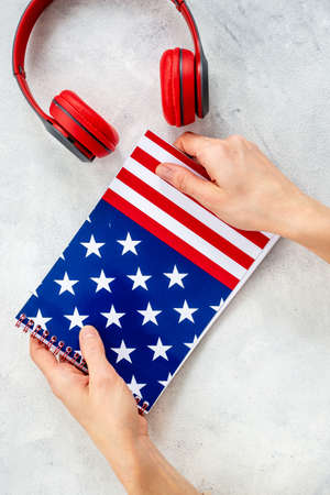 USA flag on notebook with headphones. E-learning language conceptの写真素材