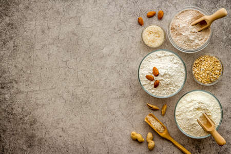 Gluten free flour for baking - nuts and grains flour in many bowlsの写真素材