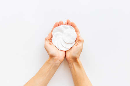 Female hands holding cotton pads for cleansing skin and careの写真素材