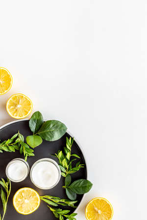 Citrus essential oil and medicine herbal cosmetic with flowersの写真素材