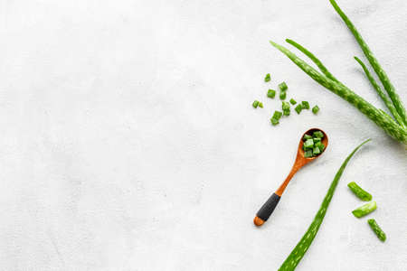 Aloe vera green leaves and slices in wooden spoon. Herbal skin careの写真素材