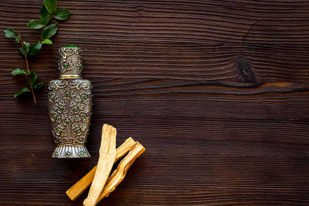 Agar wood tree oil perfume in silver bottle with sticks of treeの写真素材