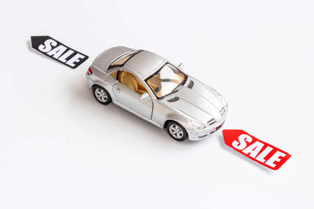Sale of cars. Price sale label with small car modelの写真素材