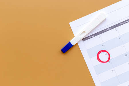 Pregnancy test with calendar to check pregnancy dayの写真素材