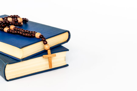 Bible book with wooden christian rosary beads with cross